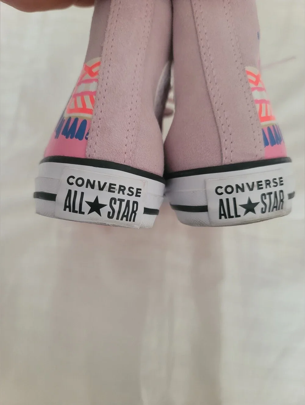 Pink Converse Chuck Taylor All Star High sneakers feature a playful llama